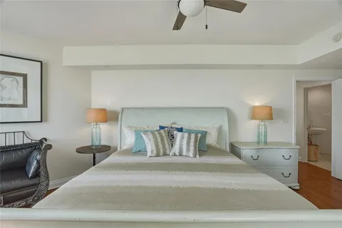 a bedroom with a bed and a lamp on table