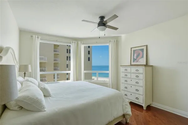 a bathroom with a granite countertop sink vanity mirror and toilet