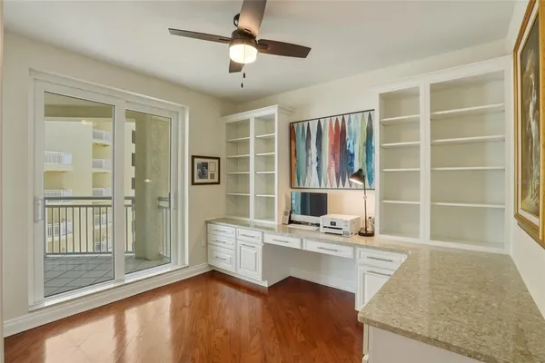 a view of a chairs and table in patio with wooden fence