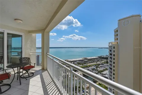 a view of a balcony with chair and wooden floor
