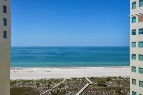a view of a field with an ocean in the background