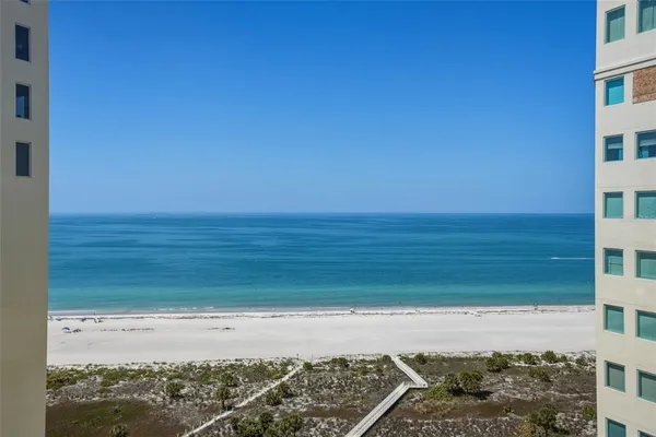 a view of a field with an ocean in the background