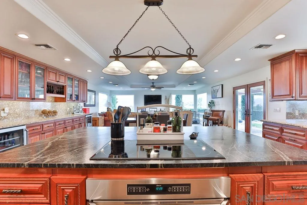 11836 Rocoso Road Lakeside, CA 92040 - Photo 3 of 65 a kitchen with stainless steel appliances granite countertop a stove and cabinets