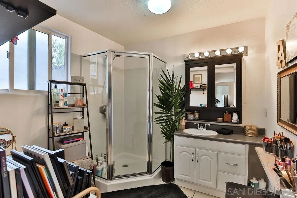 11836 Rocoso Road Lakeside, CA 92040 - Photo 33 of 65 a bathroom with a double vanity sink and a mirror