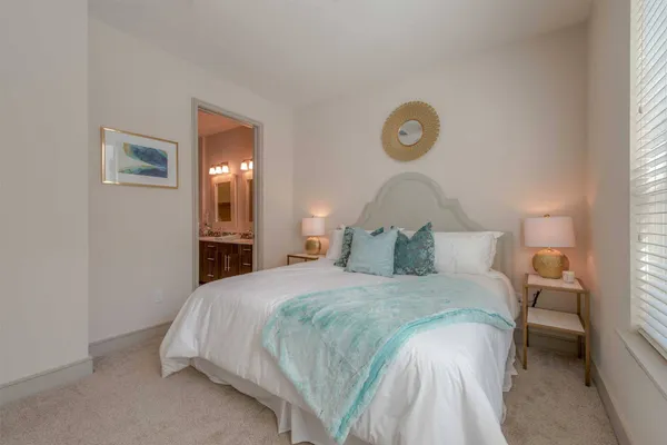 a bedroom with a bed and a lamp