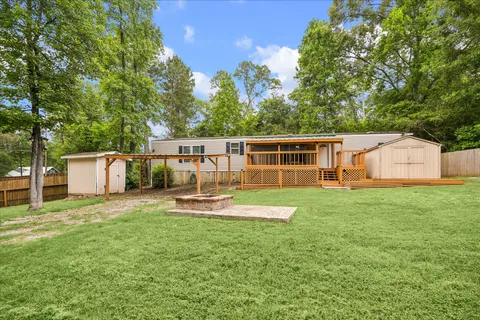 a view of a house with backyard and sitting area