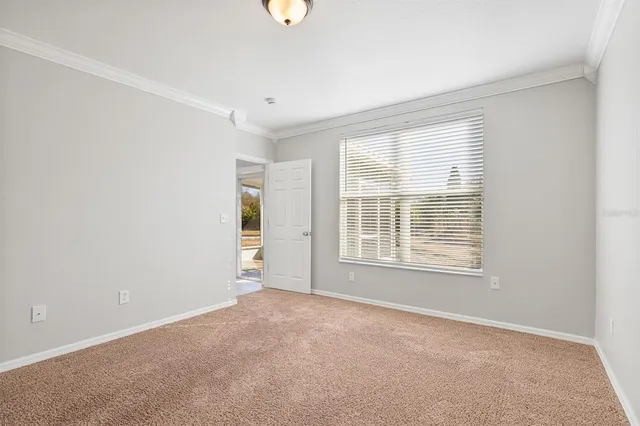 a view of a hallway with wooden cabinets