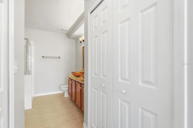 a bathroom with a granite countertop sink a toilet and shower