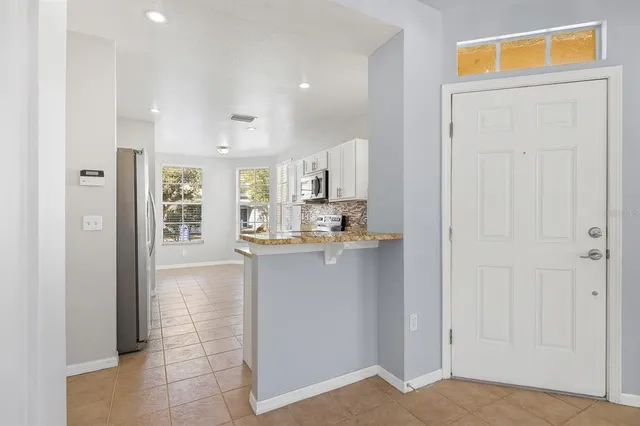 a living room with fireplace furniture and a flat screen tv