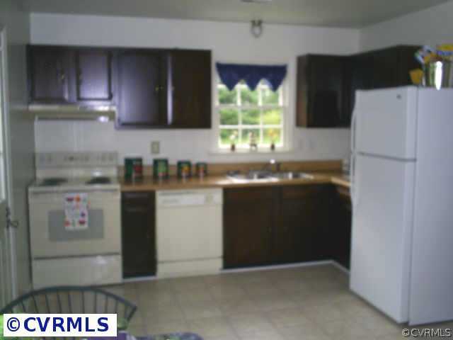 2487 Broad St Road Gum Spring, VA 23065 - Photo 6 of 7 a kitchen with stainless steel appliances granite countertop a refrigerator a stove a sink and a counter