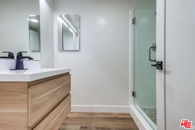 a bathroom with a granite countertop toilet and a shower