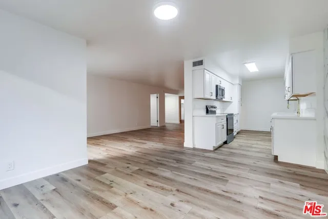 a view of kitchen and empty room