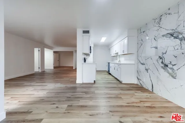 a kitchen with cabinets appliances and a counter space
