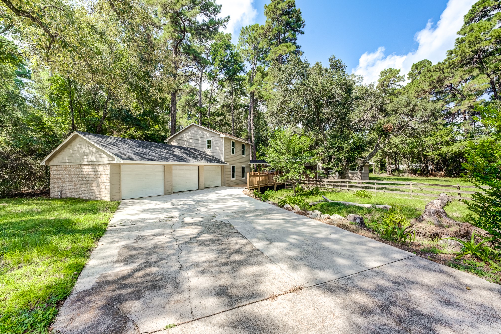 81 Oak Grove Lane Conroe, TX 77304 - Photo 2 of 50 a front view of a house with a yard and garage