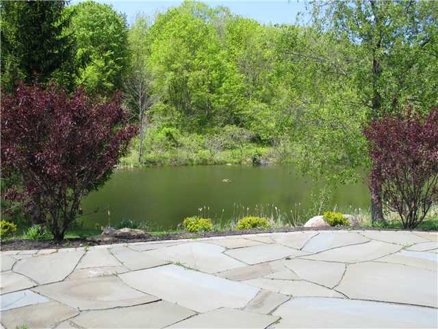 6126 Rossier Road Canandaigua Town, NY 14424 - Photo 11 of 13 Exterior Back. Bluestone patio overlooking pond -