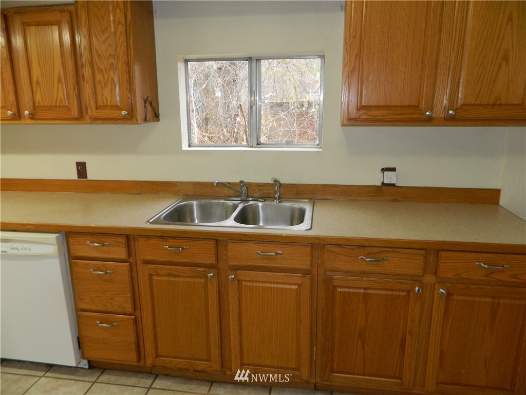 103 Cooper Street Riverside, WA 98849 - Photo 5 of 12 a kitchen with a sink and cabinets