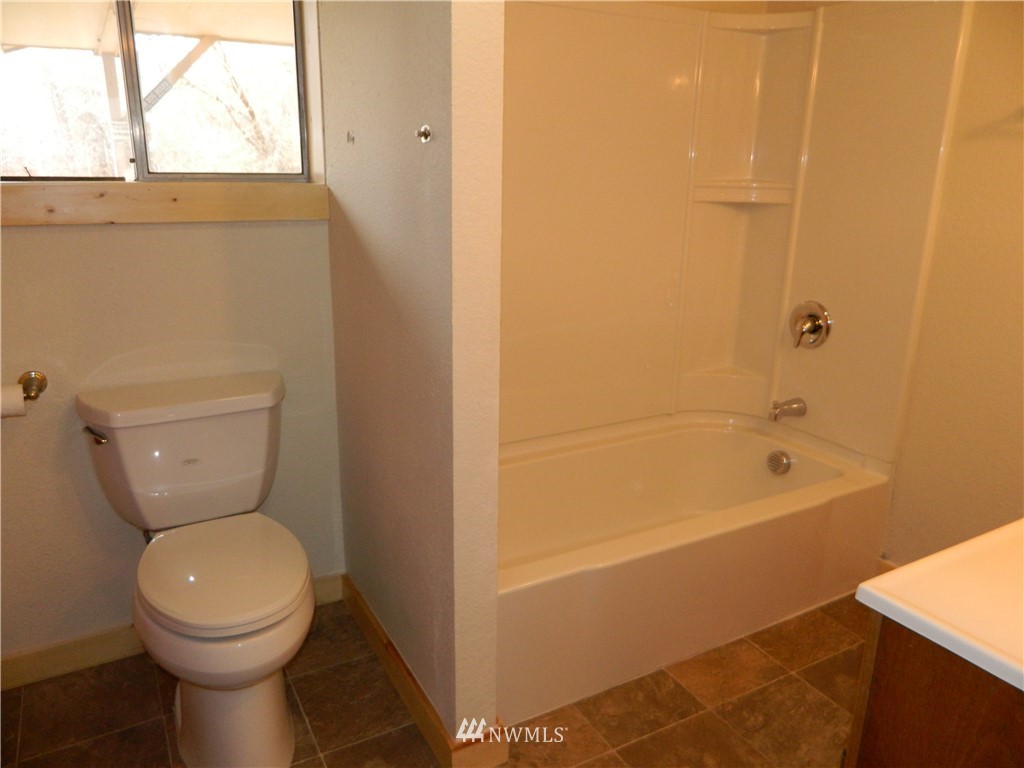 103 Cooper Street Riverside, WA 98849 - Photo 8 of 12 a bathroom with a toilet and a shower