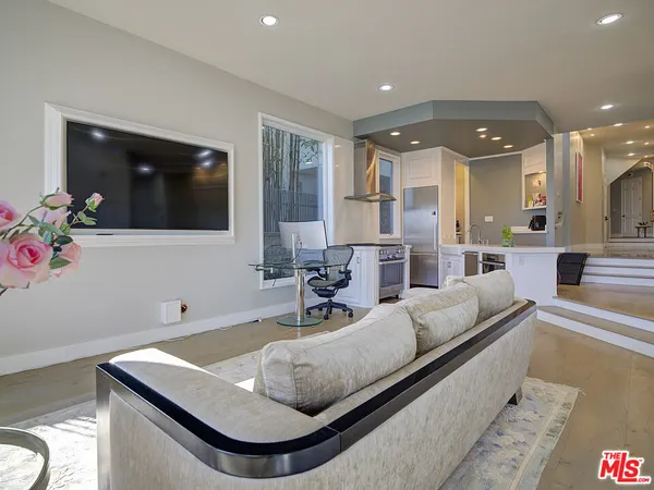 a living room with kitchen and furniture
