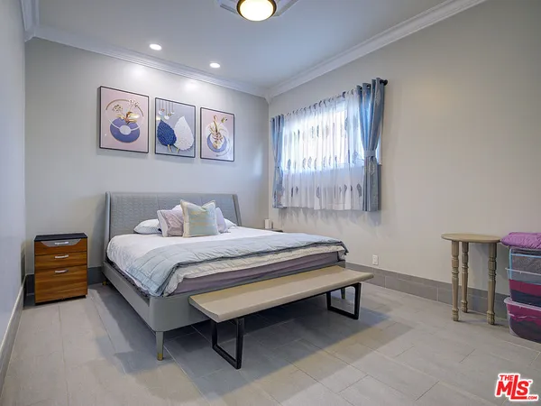 a bed room with a bed and a chair