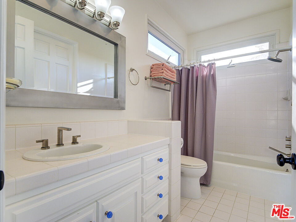 7800 Veragua Drive, Unit 1 Playa del Rey, CA 90293 - Photo 31 of 42 a bathroom with a sink a toilet a mirror a vanity and shower