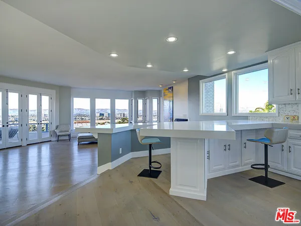 a kitchen with a sink cabinets and wooden floor