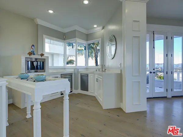 a kitchen with cabinets a counter space and a window