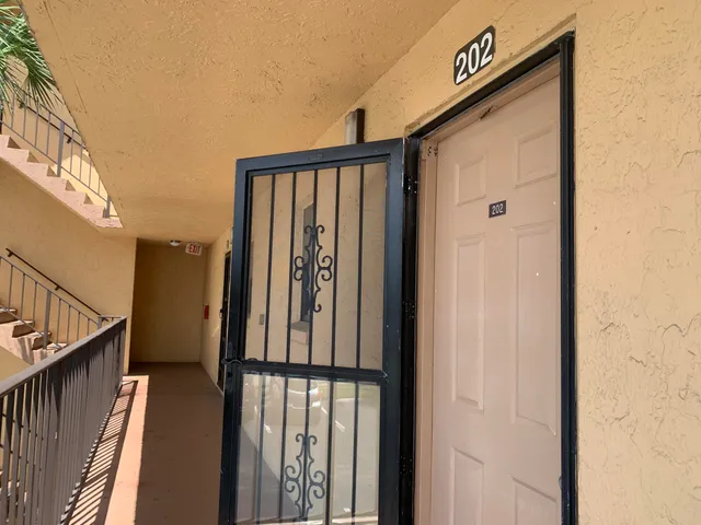 a kitchen with stainless steel appliances granite countertop a sink a stove and a refrigerator with wooden cabinets