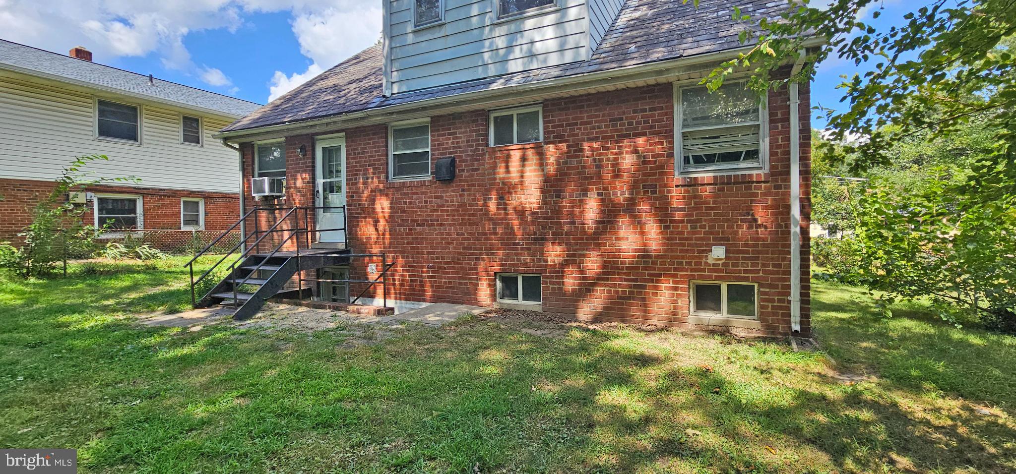 8517 Oglethorpe Street Hyattsville, MD 20784 - Photo 15 of 15 a view of a brick house with a yard and plants
