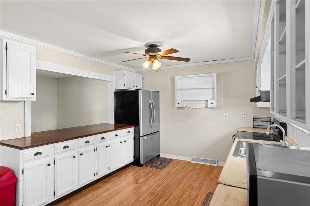 4150 Rose Marie Road Franklin, OH 45005 - Photo 23 of 36 Functional kitchen with ample cabinetry and robust wood-look flooring.