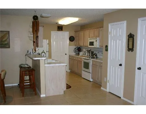 a kitchen with sink cabinets and stove top oven