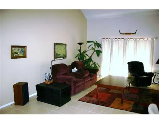 a living room with furniture rug and a window