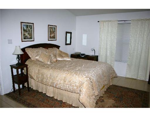15525 Dyna Street Corpus Christi, TX 78418 - Photo 5 of 8 a large white bed in a white room
