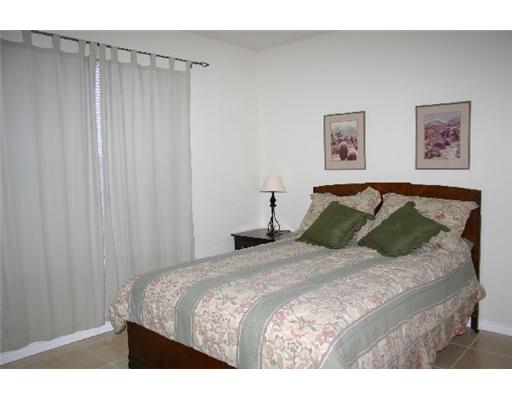 15525 Dyna Street Corpus Christi, TX 78418 - Photo 6 of 8 a bedroom with a bed and a curtain