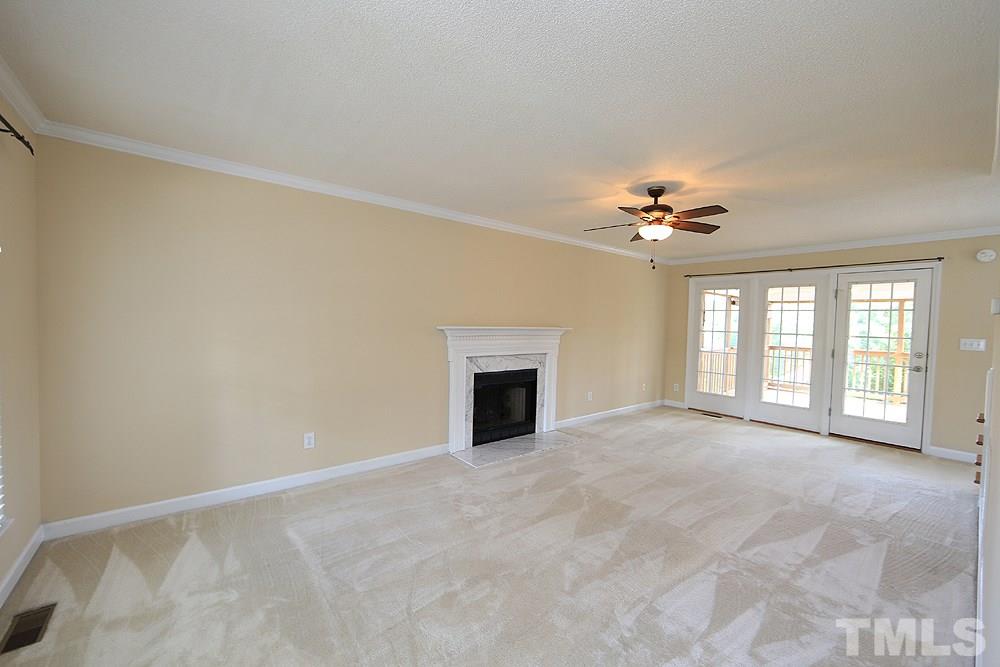 3221 Leebrook Road Raleigh, NC 27616 - Photo 3 of 12 a view of an empty room with chandelier fan and fire place