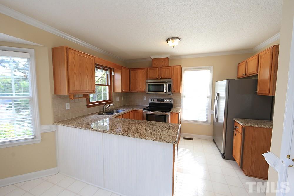 3221 Leebrook Road Raleigh, NC 27616 - Photo 5 of 12 a kitchen with granite countertop a refrigerator and a sink