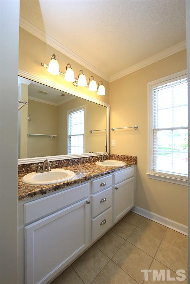 3221 Leebrook Road Raleigh, NC 27616 - Photo 8 of 12 a bathroom with a granite countertop sink and a mirror