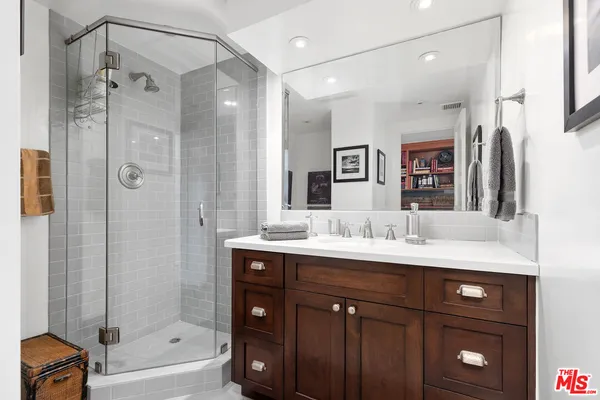 a bathroom with a granite countertop sink mirror and shower