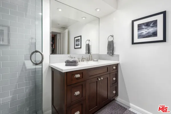 a bathroom with a sink mirror and vanity