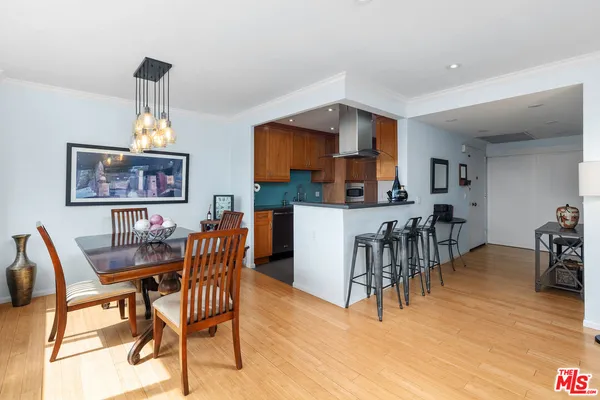 a dining room with furniture a window and wooden floor