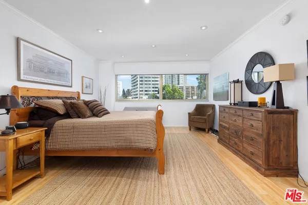 a bedroom with furniture and a window