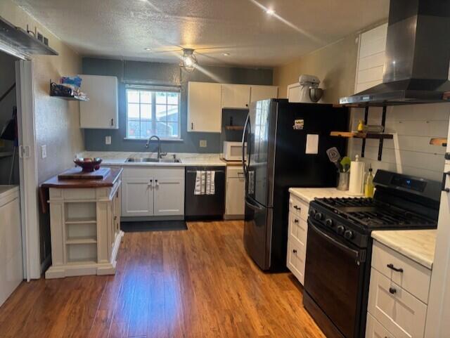 20158 Mapleleaf Street Burney, CA 96013 - Photo 12 of 33 a kitchen with stainless steel appliances a stove a sink dishwasher a refrigerator and a stove with wooden floors