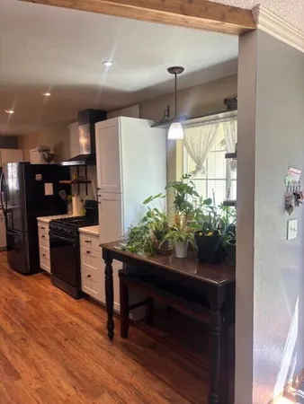a kitchen with stainless steel appliances kitchen island granite countertop a refrigerator and a stove top oven