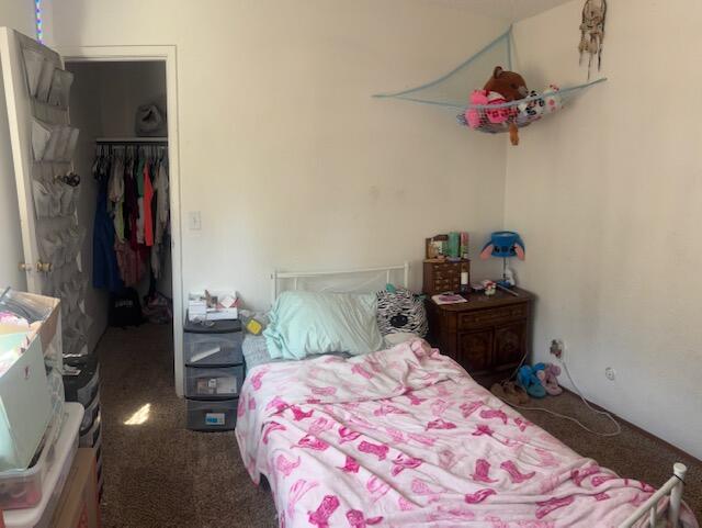 20158 Mapleleaf Street Burney, CA 96013 - Photo 20 of 33 a bedroom with a bed and a chandelier