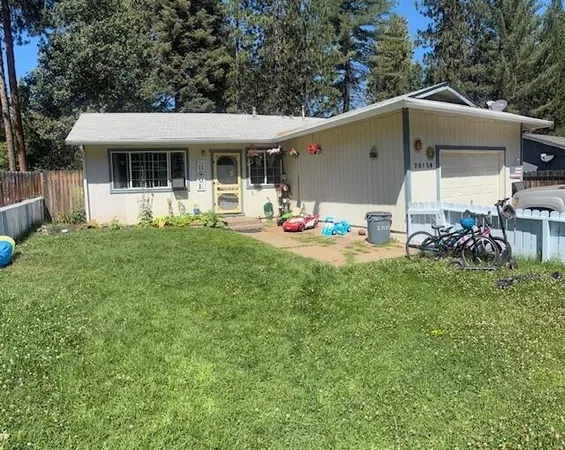 a view of a house with backyard sitting area and garden