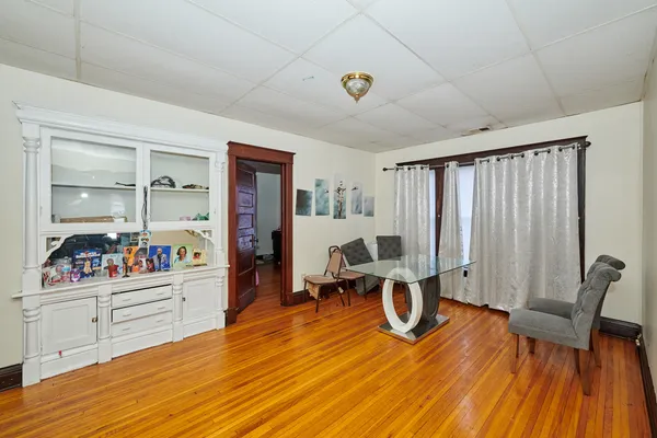 a view of a room with wooden floor and windows
