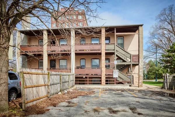 a view of a patio with couches chairs and wooden floor