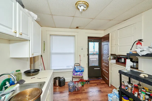 a kitchen with refrigerator a stove a sink and a window
