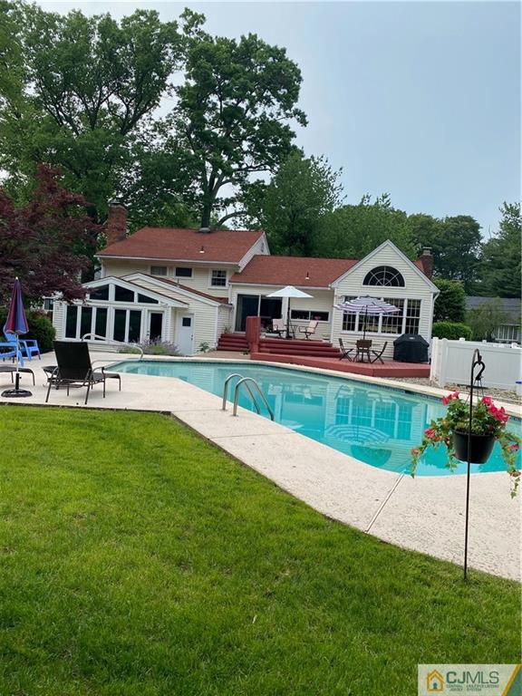 20 Clive Hills Road Edison, NJ 08820 - Photo 4 of 55 a front view of a house with a yard table and chairs