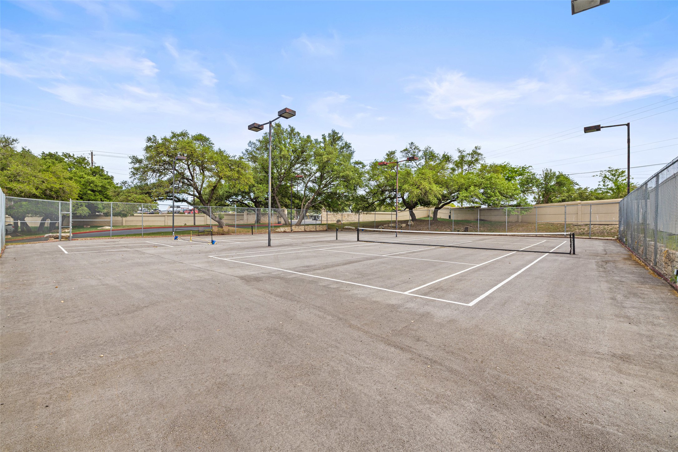 2918 Ranch To Market Road 620, Unit O282 Austin, TX 78734 - Photo 33 of 40 View of tennis court with fence