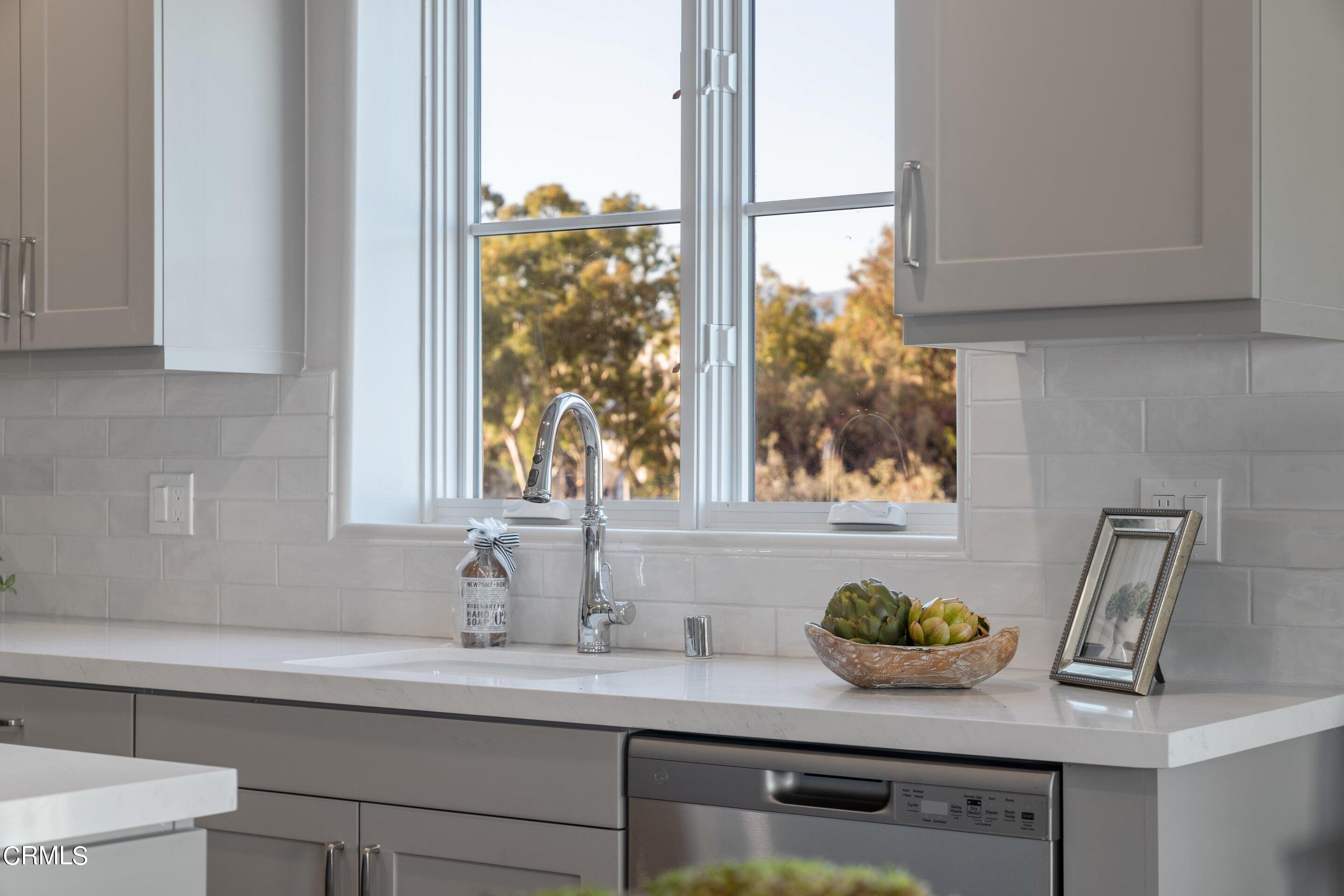 88 North Oakland Avenue, Unit 504 Pasadena, CA 91101 - Photo 28 of 46 a bathroom with a granite countertop sink and a white cabinets